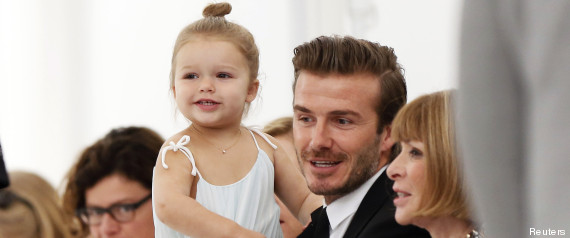 Former England soccer captain David Beckham holds his daughter Harper as he speaks to Vogue editor Anna Wintour while waiting for a presentation of the Victoria Beckham Spring/Summer 2014 collection during New York Fashion Week